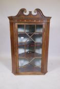 A C19th mahogany hanging corner cupboard with an astragal glazed door, with painted and inlaid