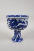 A Ming style blue and white porcelain stem bowl/goblet, decorated with dragons in flight, Chinese