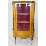 A French mahogany vitrine with tulipwood banded inlay, brass mounts and serpentine front, raised