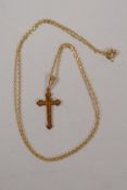 A delicate 9ct gold crucifix on a fine 16" gold chain, gross 1g