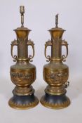 A pair of Japanese Meiji period bronze vases converted to lamps, with two dragon mask handles, and