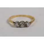 An 18ct yellow gold three stone diamond ring, size L