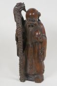A carved rootwood figure of the immortal Shao Lao with dragon staff and peach, 11½" high