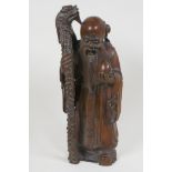 A carved rootwood figure of the immortal Shao Lao with dragon staff and peach, 11½" high