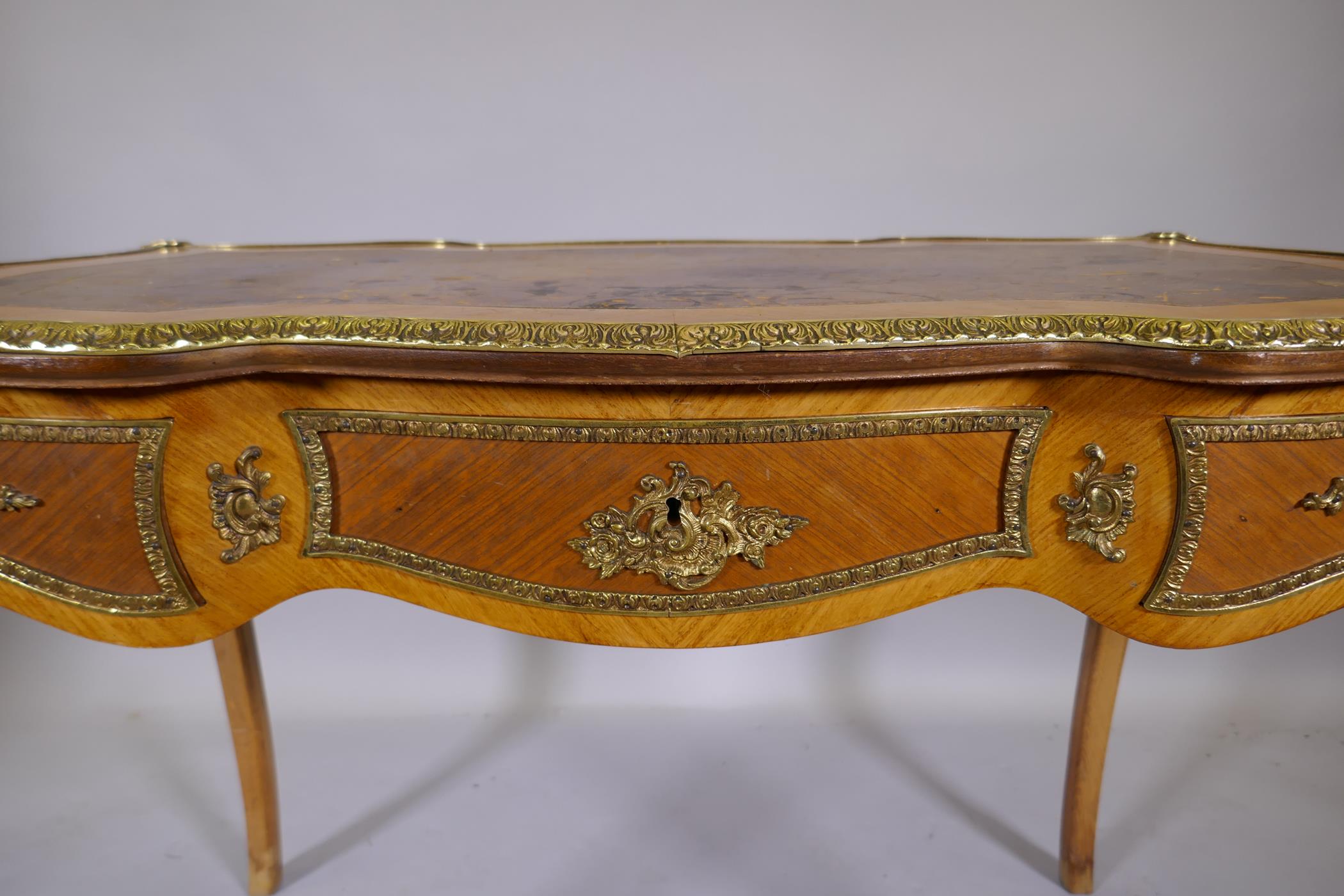 A Louis XV style inlaid tulipwood and brass mounted writing table, with inset leather top and three - Image 4 of 9