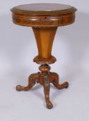 A Victorian walnut workbox, the top with carved edge and frieze, raised on a trumpet shaped column