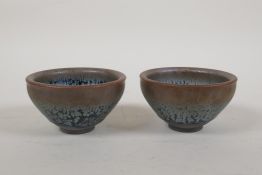 A pair of Jian ware pottery tea bowls with an iridescent drip glaze, 3½" diameter