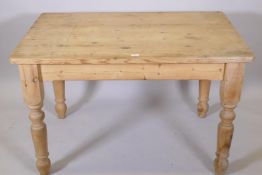 A pine scullery table, raised on turned supports, 48" x 33" x 31"