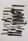A collection of miscellaneous fountain pen parts including nibs, cases, pocket clips, lids etc
