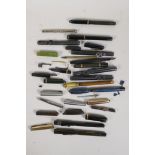 A collection of miscellaneous fountain pen parts including nibs, cases, pocket clips, lids etc
