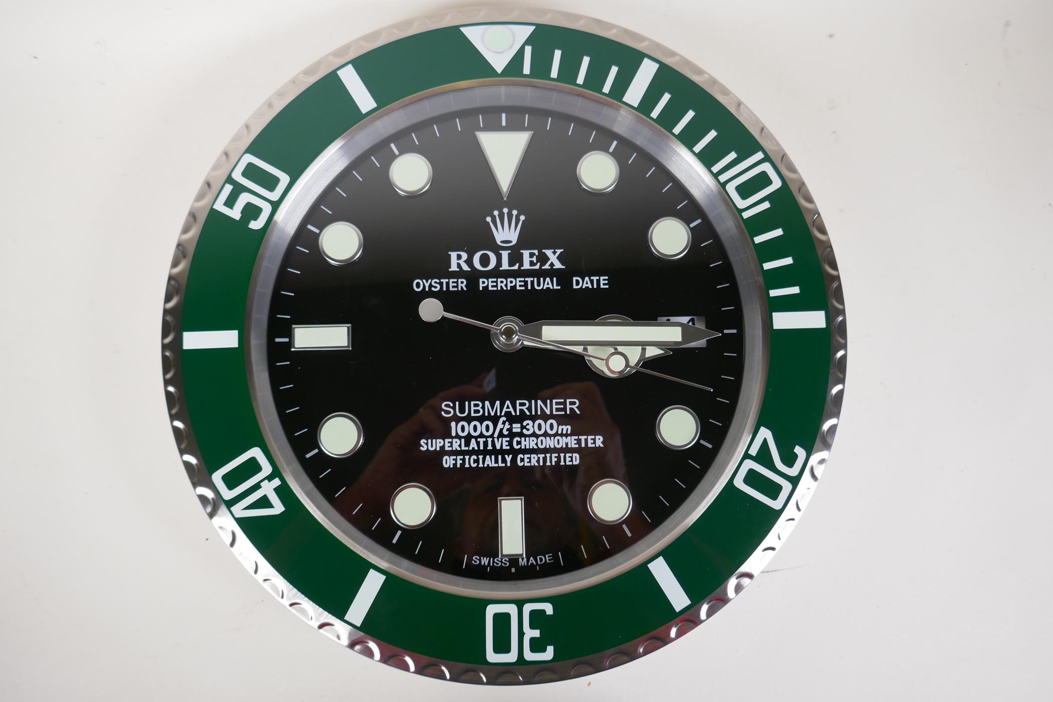 A circular wall clock with quartz movement, the dial decorated in the manner of a Rolex Oyster