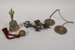A collection of Tibetan items including a pair of cymbals, a bell, a rattle and two bronze