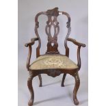 A C19th walnut open arm elbow chair with carved and pierced splat back, shaped drop in seat,