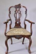 A C19th walnut open arm elbow chair with carved and pierced splat back, shaped drop in seat,