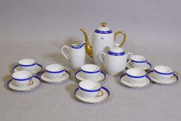 A Limoges eight place coffee set with blue and gilt borders