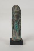 An Egyptian turquoise glazed faience shabti, mounted on a display base, 5" high