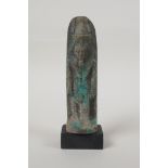 An Egyptian turquoise glazed faience shabti, mounted on a display base, 5" high