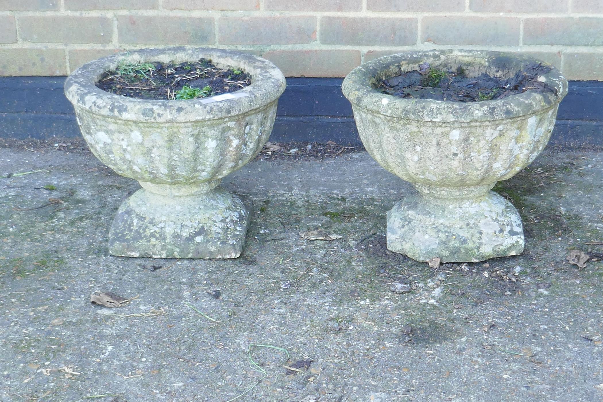 A pair of vintage reconstituted stone garden urns