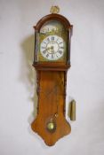 A C19th Dutch Frisland tall wall clock, with painted dial and alarm, striking on a bell, 55" long