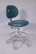 An A-Dec dental practitioner's stool, adjustable
