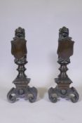 A pair of bronze andirons in the form of lions bearing heraldic shields, 24" high