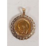 A 1914 King George V Gold Sovereign in a pierced 9ct gold mount, gross 11.8g
