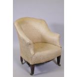 A Victorian tub shaped nursing chair, raised on square tapering supports with brass castors, 31"