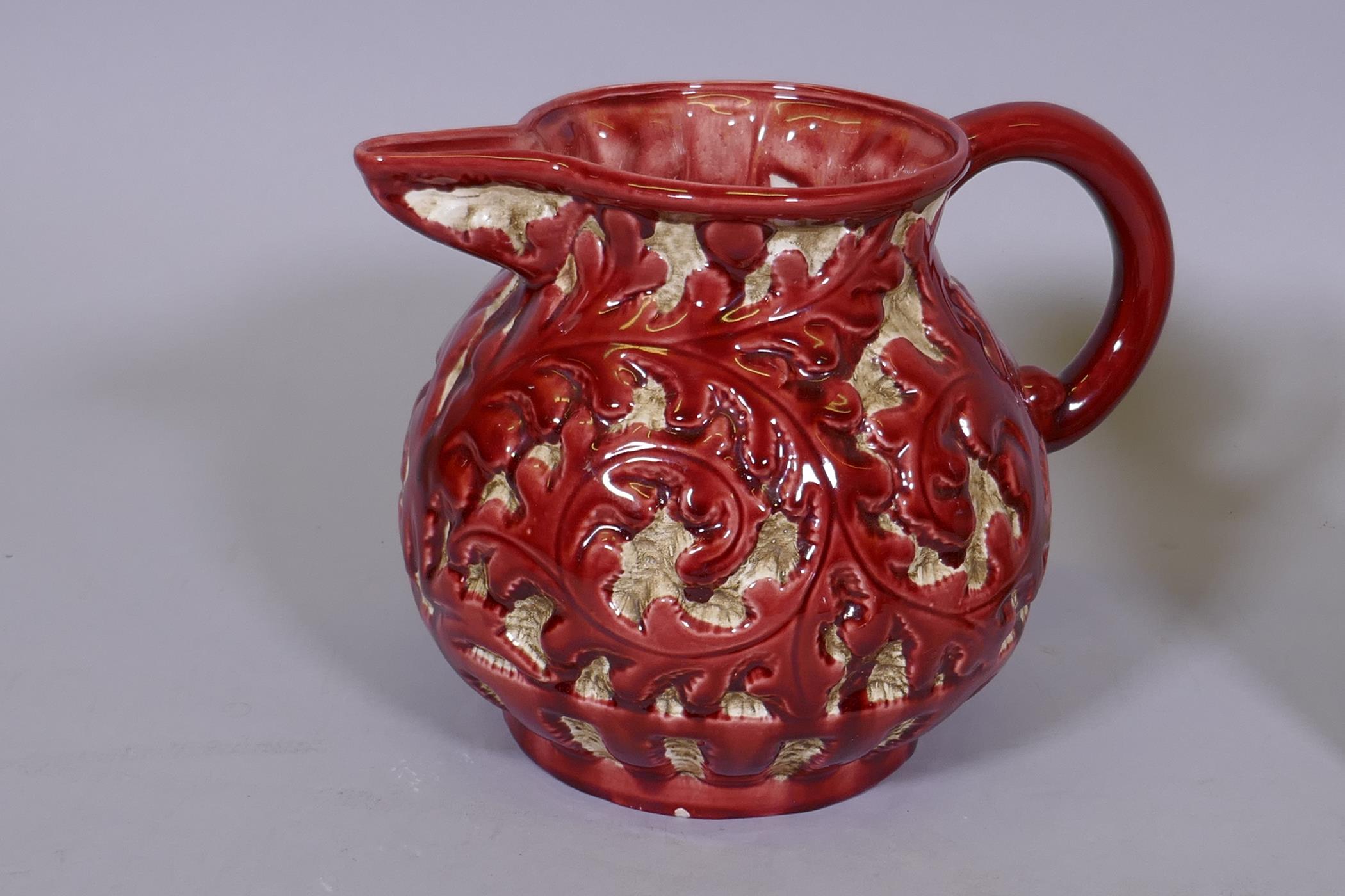 Trentham majolica jug with raised foliate design, glazed in red, 9" high, and a studio pottery - Image 3 of 4