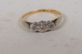 A gold and platinum set three stone diamond ring, size N/O, gross 1.9g