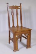 An Arts and Crafts oak side chair, with pierced splat back and front supports