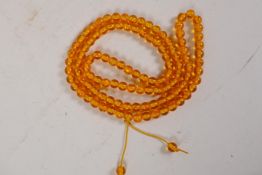 A faux amber bead necklace, 42" long