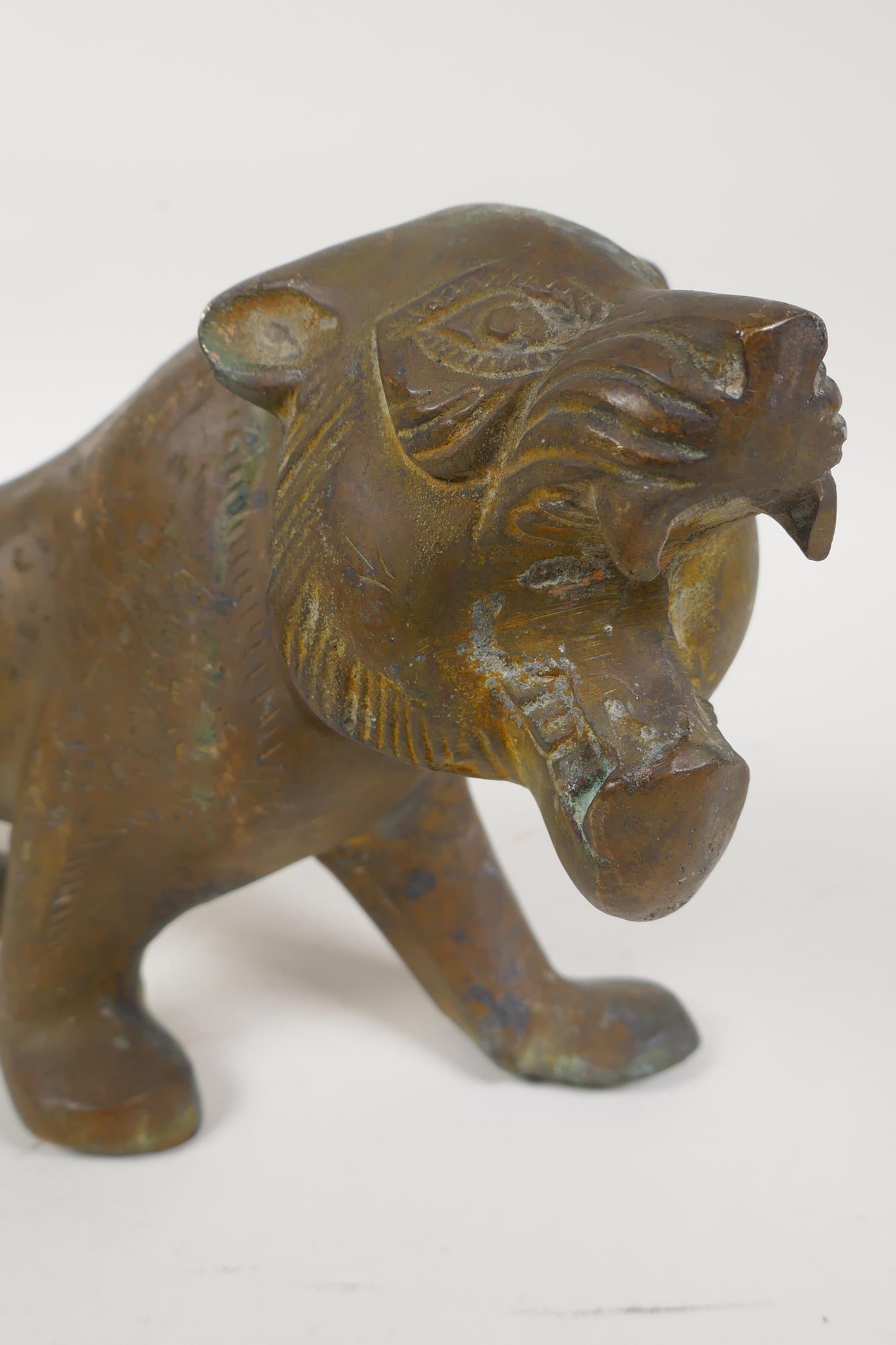 An Eastern stylised yellow metal figure of a lion, 15" long - Image 6 of 6