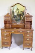 Shapland & Petter of Barnstaple, inlaid mahogany kneehole dressing table with shield shaped