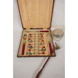 An Art Deco cased set of 'Berry' coffee spoons, jam spoon, butter knife and pickle fork, a