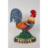 A brightly painted cast iron door stop in the form of a cockerel, 13" high