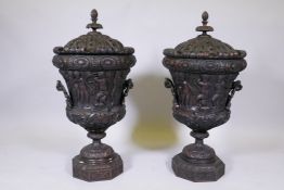 A pair of wood urns and covers, the frieze carved with a procession of cherubs following Bacchus