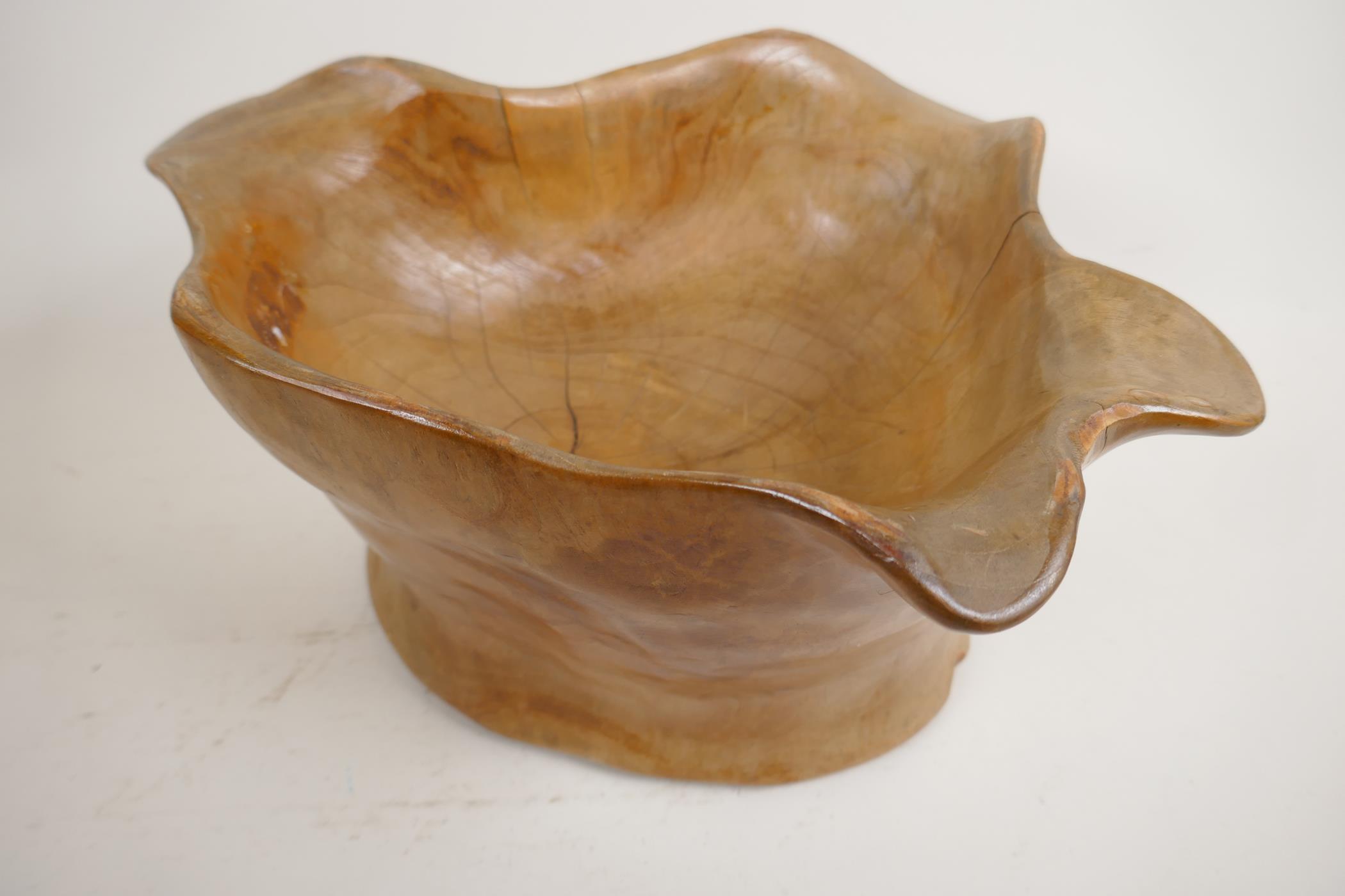 A carved root wood bowl, 7" high