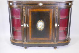 A C19th ebonised and inlaid credenza with brass mounts and inset Sevres style painted plaques, two