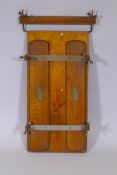 An Edwardian trouser press with metal straps and painted detail, 17" x 31"