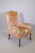 A Victorian armchair raised on mahogany supports with pad feet