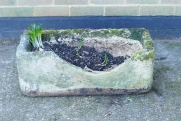 An antique stone feeding trough, worn from use, 27" x 12" x 10"