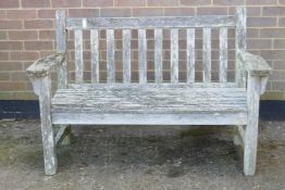 A Barlow Tyrie weathered teak garden bench, 53" wide