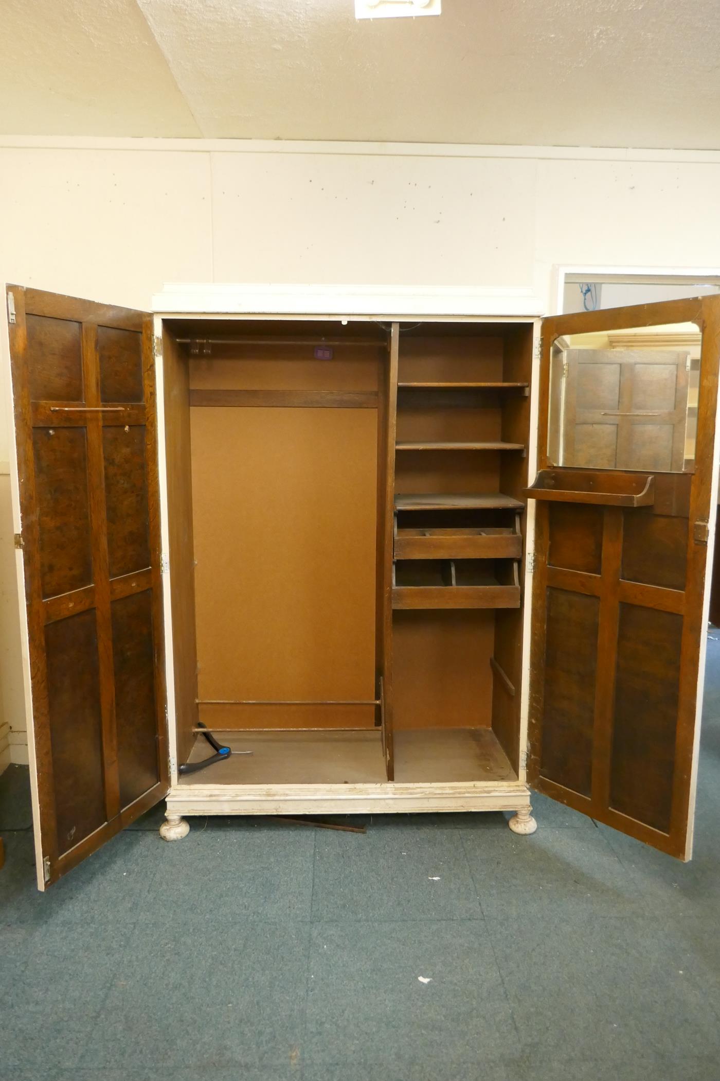 A 1930s painted oak Jacobean style wardrobe, with fitted interior, raised on squashed bun - Image 2 of 2