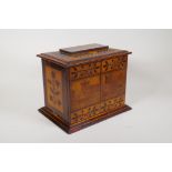 A C19th Killarney ware inlaid table cabinet with lift up top and two doors opening to reveal three