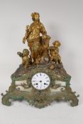 A C19th French spelter mantel clock adorned with Baccanalian figures, with twin train movement