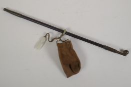 A Chinese tobacco pipe with bronze mounts, and attached tobacco pouch with jade toggle, 17" long