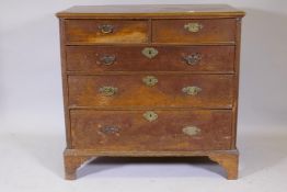 An C18th Georgian oak chest of two over three drawers, with moulded front and bracket supports,