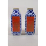 A pair of blue and white porcelain vases with red and gilt decorative panels depicting birds and