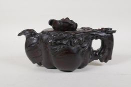 A Chinese carved hardwood teapot with flowering branch decoration, 9½" long, no spout hole