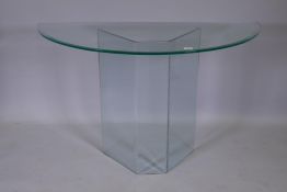 A contemporary glass demi-lune console table with bevelled edge top, 48" x 20" x 30"